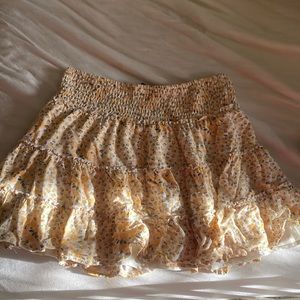 An American Eagle skirt that has orangish yellow flowers.